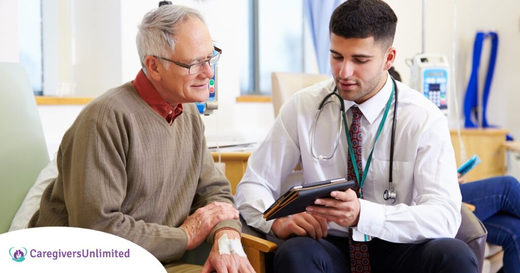 An older man talks with a doctor representing the effective communication that family caregivers should endeavor to have.