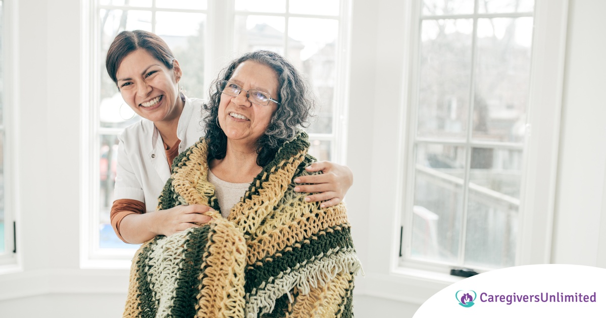 A caregiver hugs an older client representing the kind of good environment a caregiver has the potential to create with new clients.