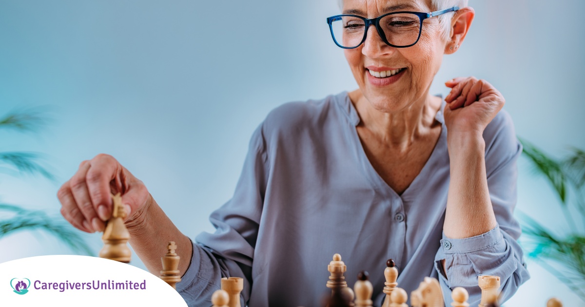 An older woman plays chess, an activity that can help older adults stay sharp.