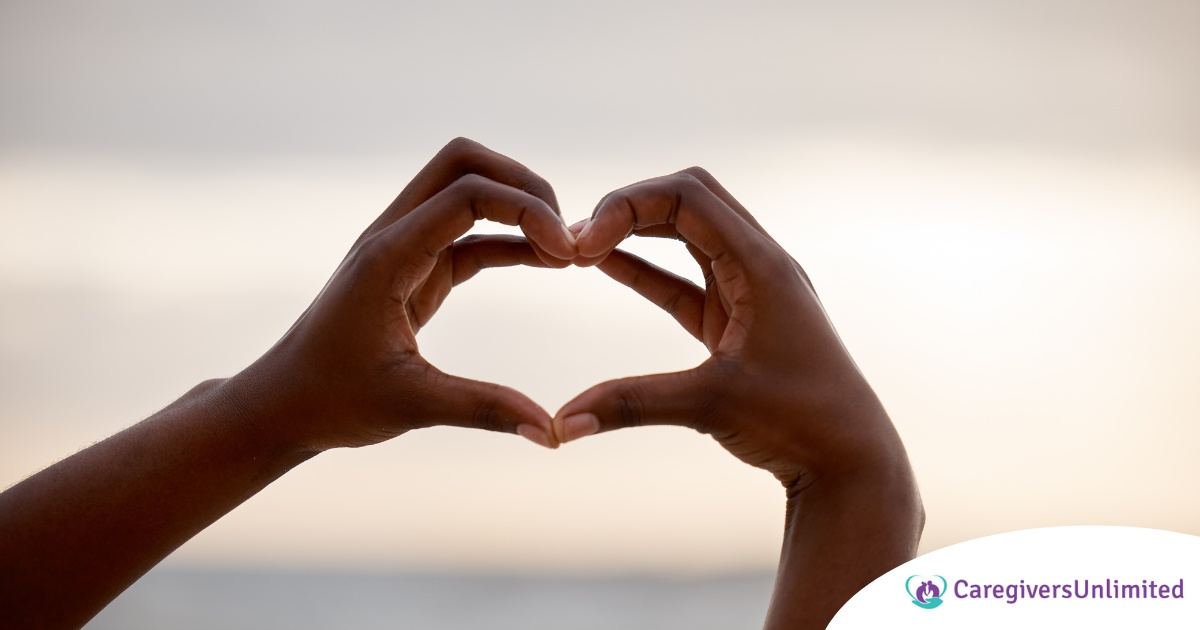 2 hands making a heart represent self-care, a vital concept to appreciate as a caregiver.