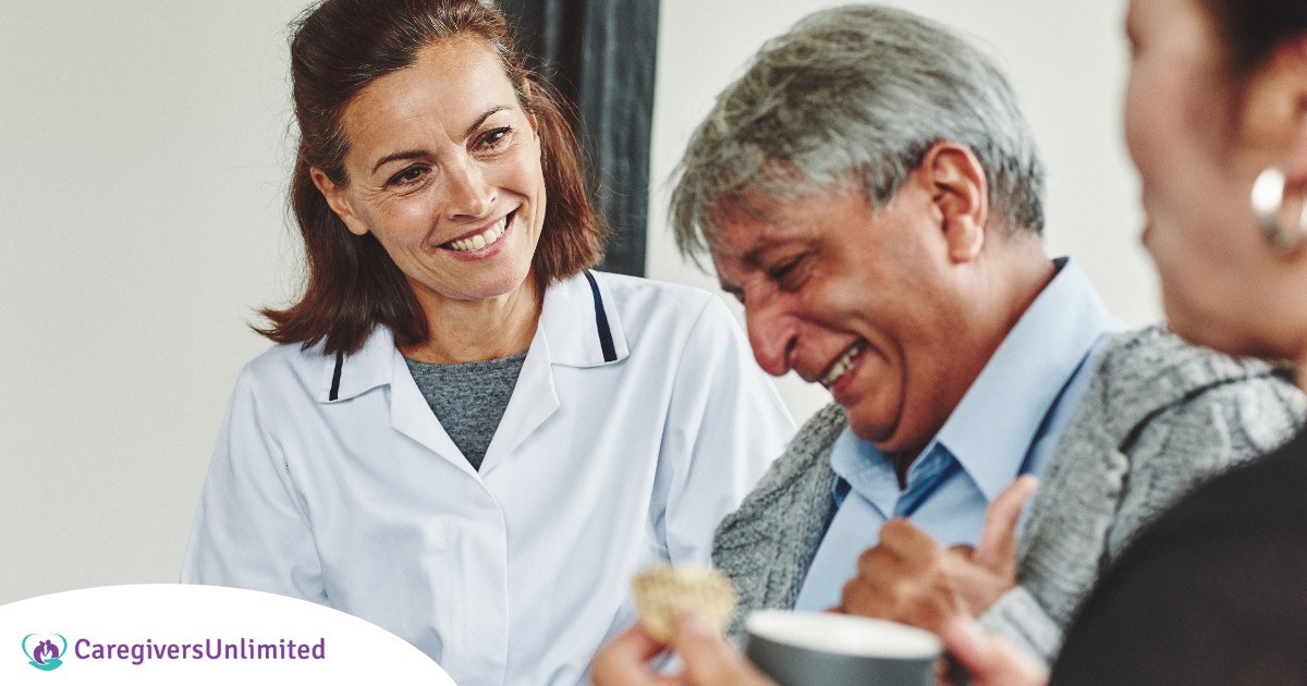 A woman smiles while with clients showing how you can enjoy senior caregiver jobs.